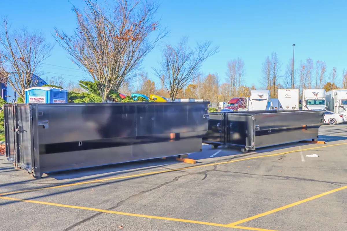 Professional dumpster rental service with roll-off container on residential driveway in Canyon